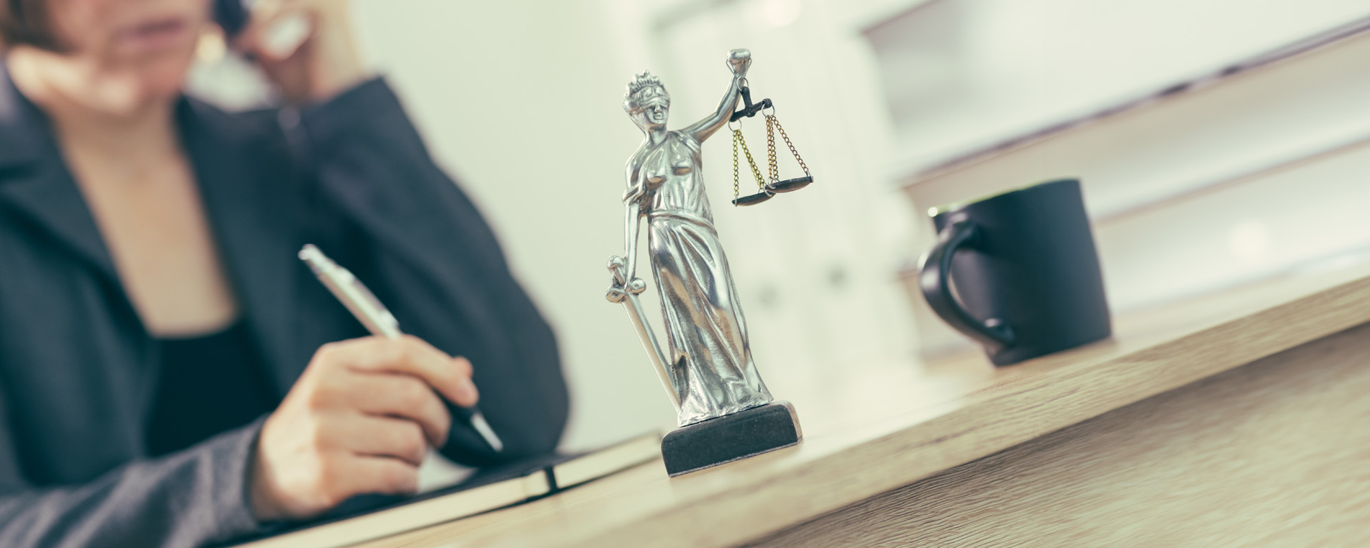 attorney woman talking on mobile phone from her office desk