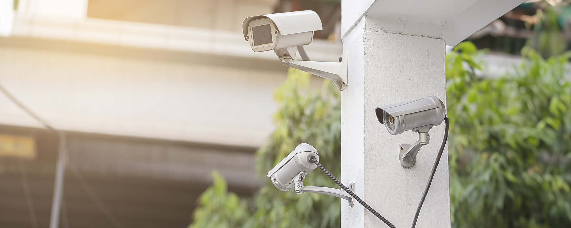 cctv on the white wall with orange light