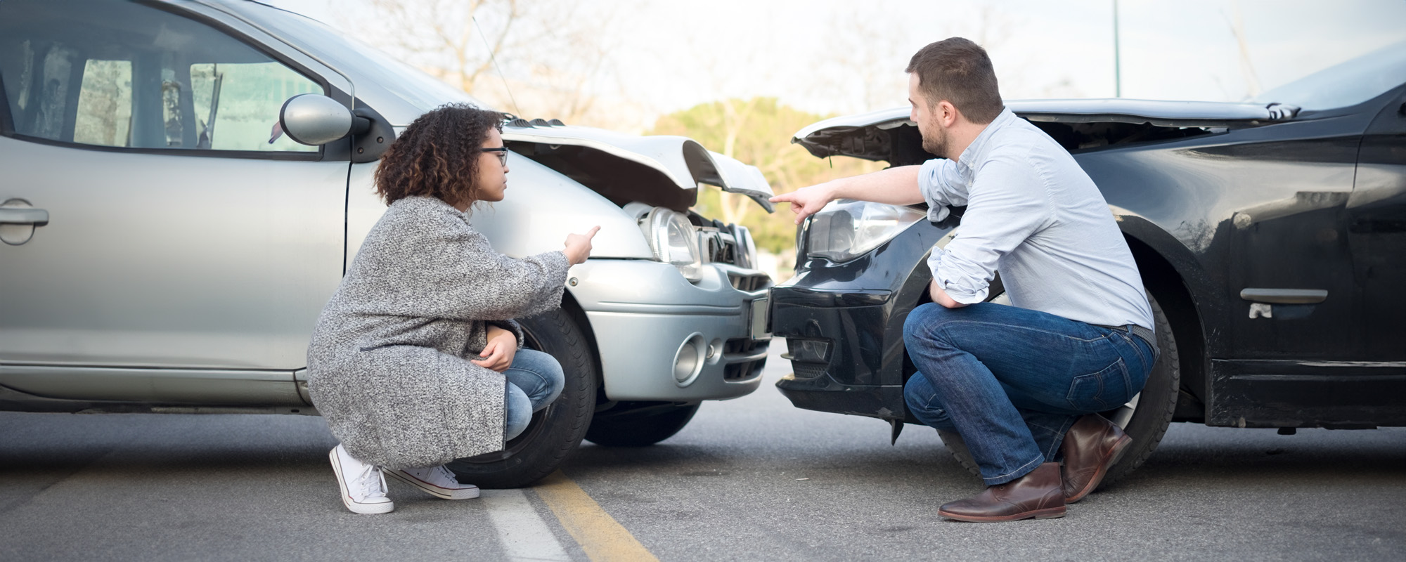 man and woman arguing after a car crash