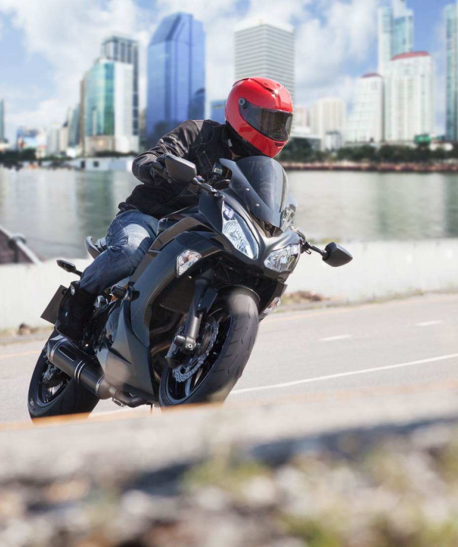 man riding a motorcycle on a city road