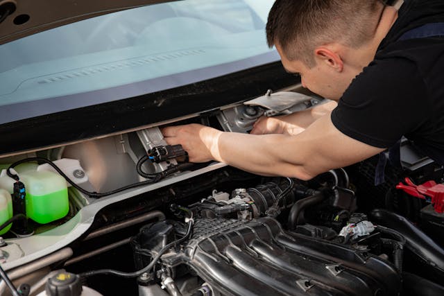 mechanic working on car engine